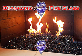 Black Reflective Nugget Fire Glass in an indoor fireplace
